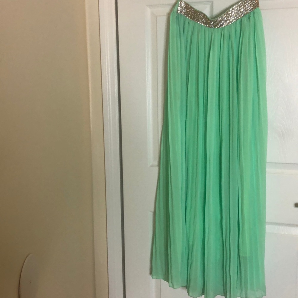 Green, lined, pleated skirt. Rhinestone front band